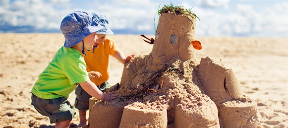 Family Travel insurance. Kids playing on the beach