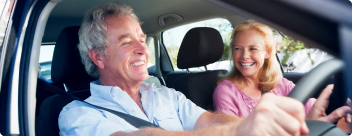 couple in a care, sharing a joke